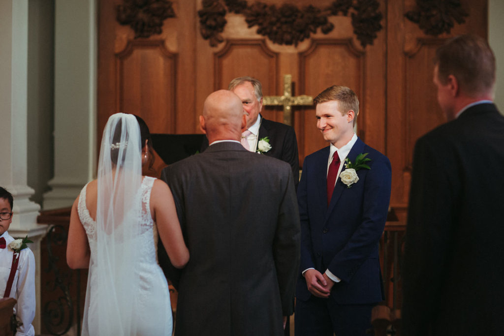 bride is given away by her father at the altar during this intimate atlanta elopement