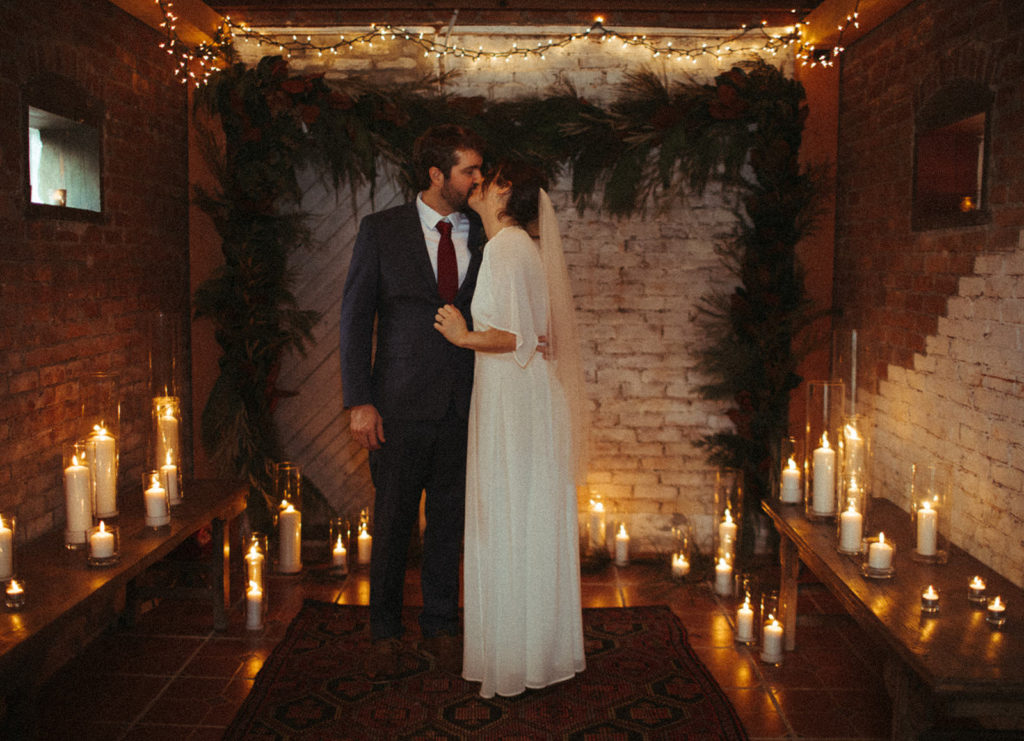couple shares a kiss after their initimate elopement