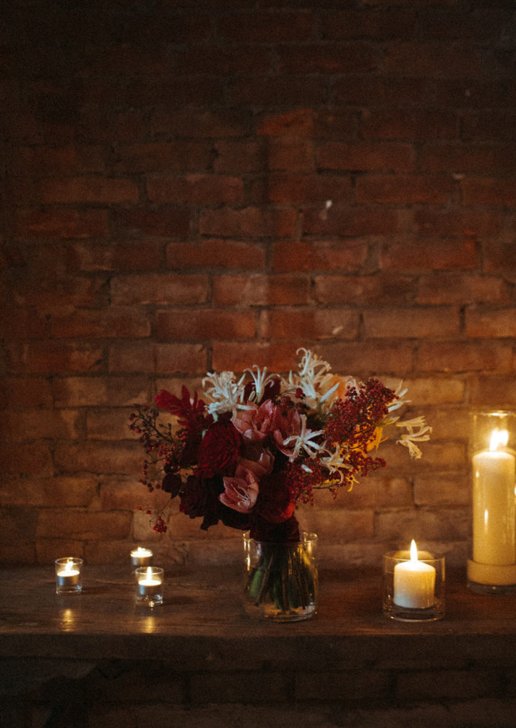 a bouquet surrounded by candles in the ice house