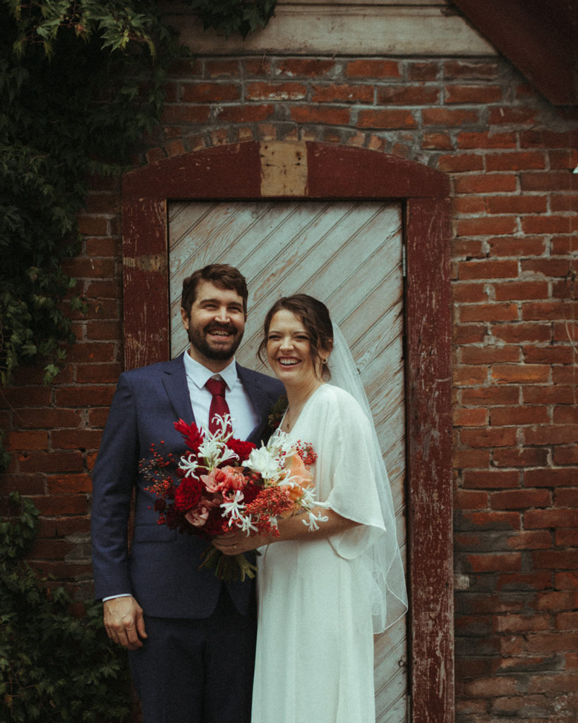 couple posing for wedding photos after an intimate elopement at the ruby june inn
