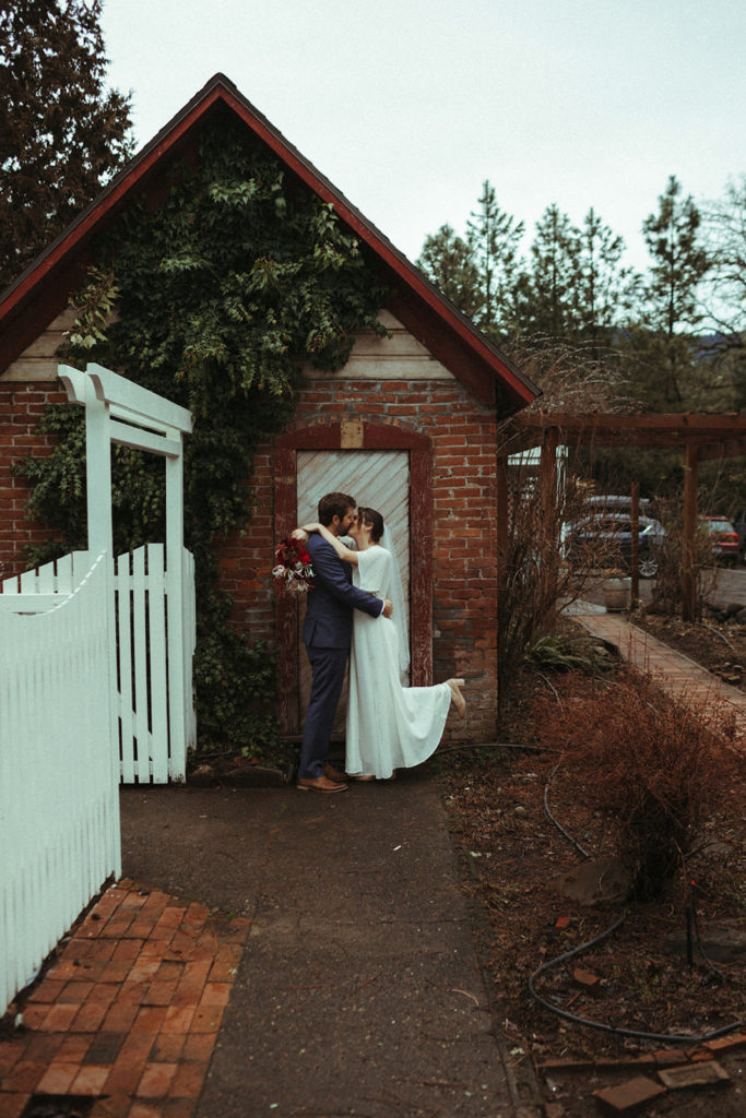 couple posing for wedding photos after an intimate elopement at the ruby june inn