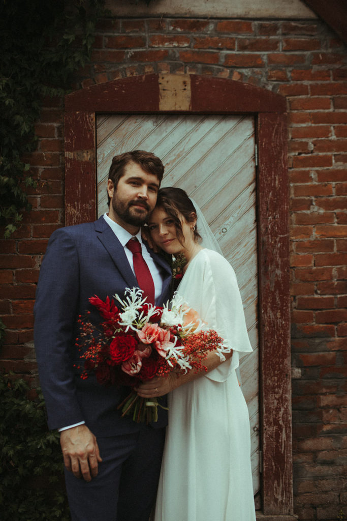 couple posing for wedding photos after an intimate elopement at the ruby june inn