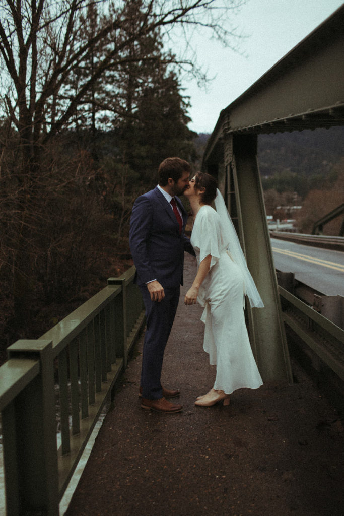couple posing for wedding photos in white salmon washington at the husum falls bridge