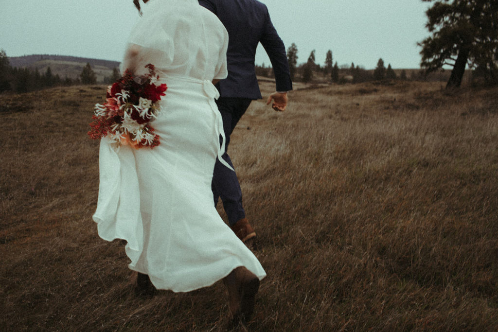 couple running through the columbia river gorge after their intimate elopement