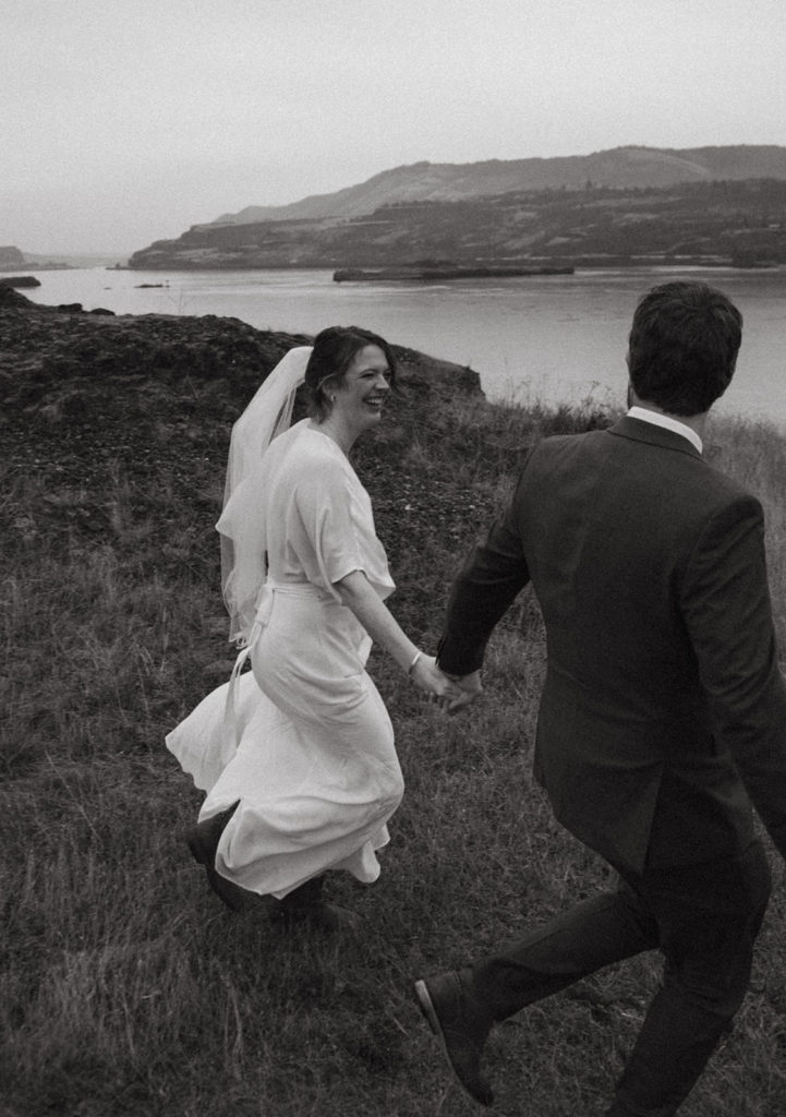 couple running through the columbia river gorge after their intimate elopement