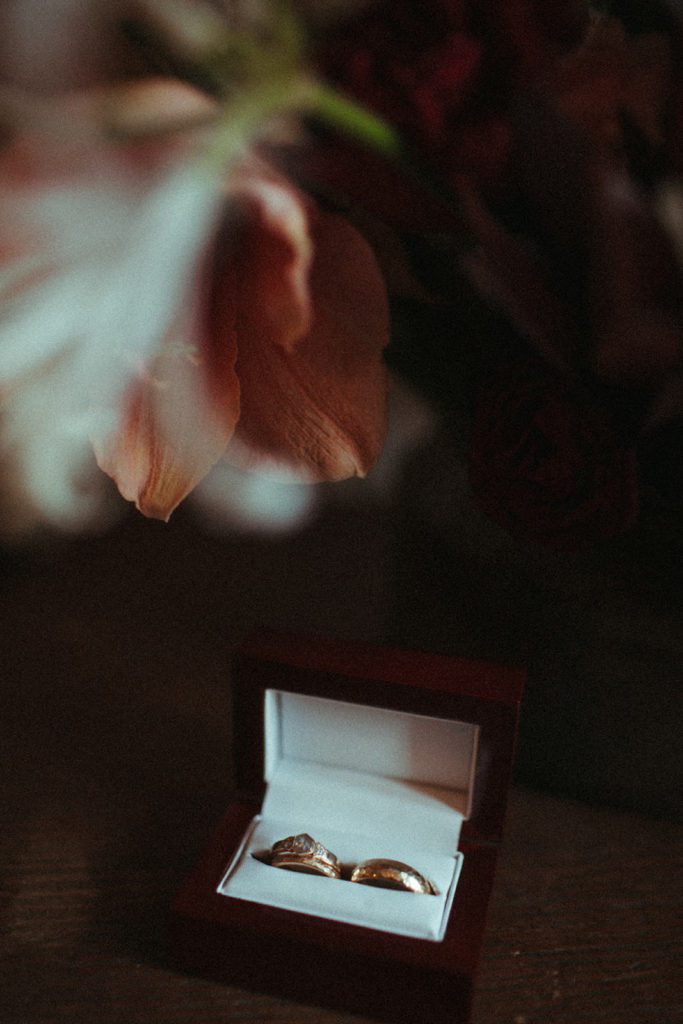 wedding rings under a bouquet