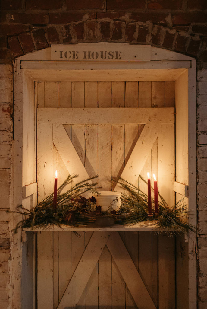a wedding cake surrounded by candles