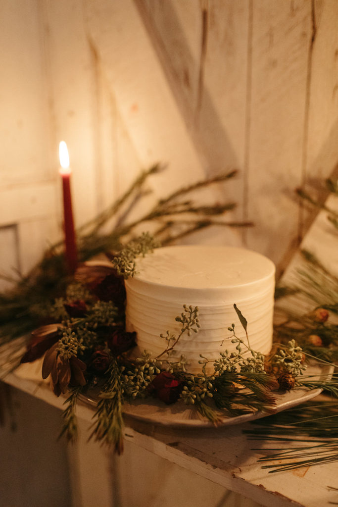 a wedding cake surrounded by candles