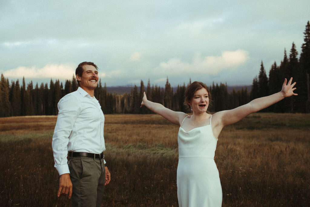 couple cheering after being congratulated on their new marriage