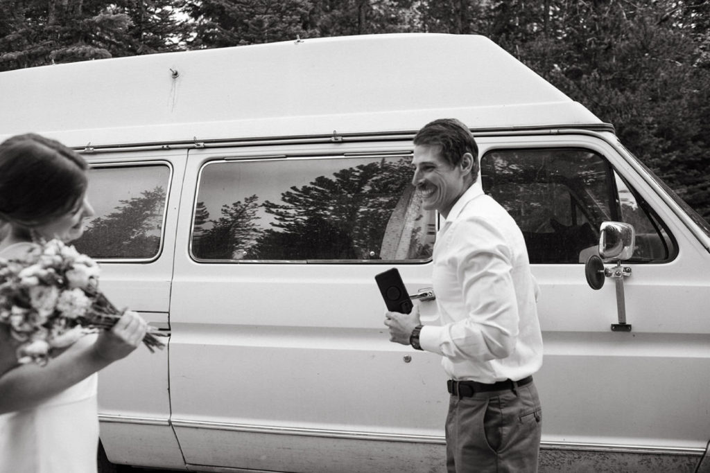 groom smiles at bride when he sees her in dress for the first time