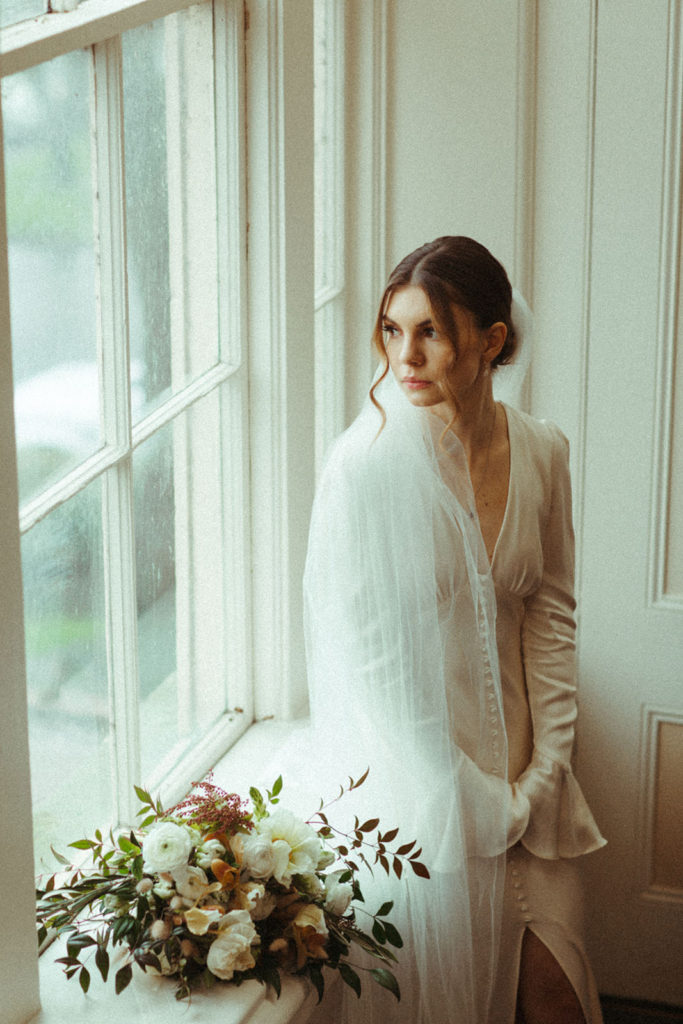 bride stares out the window before her wedding in Vancouver Washington