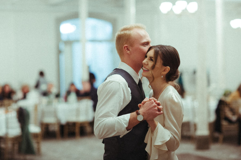bride and groom smile as they share their first dance during a wintry wedding in vancouver washington